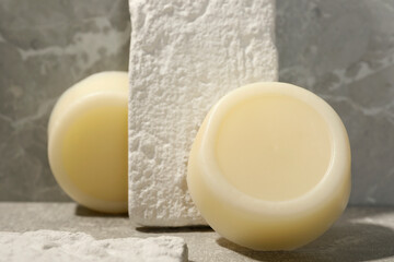 Solid shampoo bars on grey marble background, closeup. Hair care