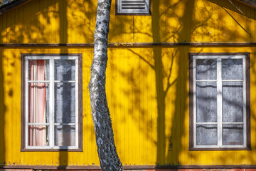 Yellow traditional ornate wooden farm house of eastern Europe, Lithuania