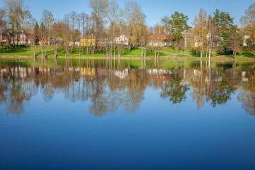 Fototapeta na wymiar Peaceful city park and church on the lake Druskonis reflection, lithuania
