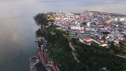 Aerial view of Cacilhas small township at sunset along the Tagus river with Lisbon city center in background, Almada, Portugal.