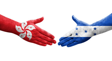 Obraz premium Handshake between Honduras and Hong Kong flags painted on hands, isolated transparent image.