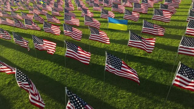 Ukrainian and American flags representing multinational victims of terror attack. Drone shot of Pepperdine University's Waves of Flags honor September 11 lives. High quality 4k footage