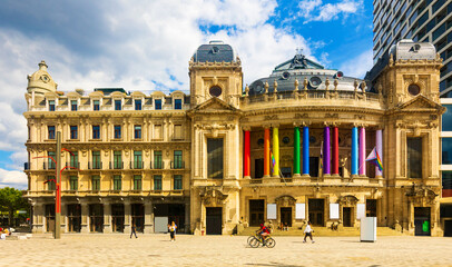View of medieval baroque building of Flemish Opera in Antwerp with facade columns painted in rainbow colors during traditional annual Gay Pride, Belgium