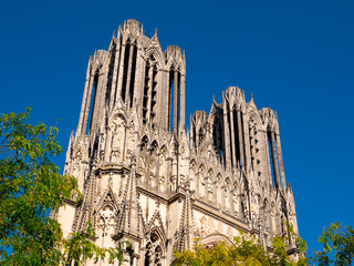 View of magnificent gothic building of Notre-Dame de Reims, Roman Catholic cathedral in Place du...