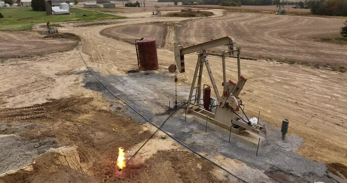 Pumpjack Moves up and Down Fracking for Oil in the Midwest USA