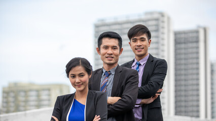 A group of business women and business men working outside the office.