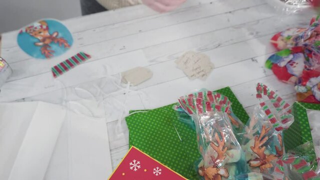 Step by step. Packaging homemade macadamia fudge into small gift bags.