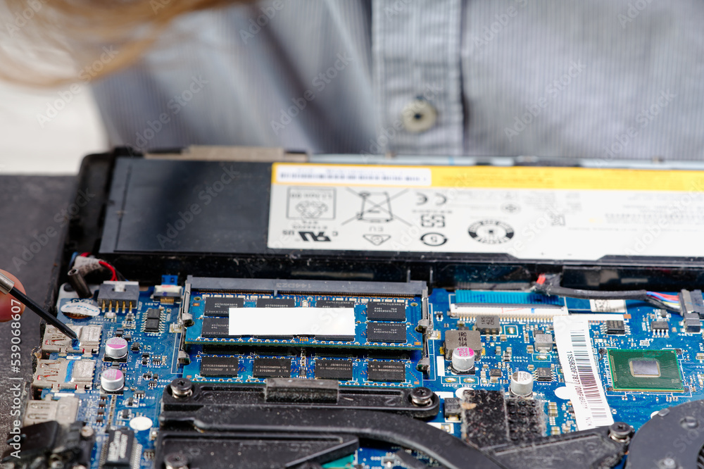 Poster notebook repair. man disassembles a laptop. removes the keyboard. computer service and repair concep