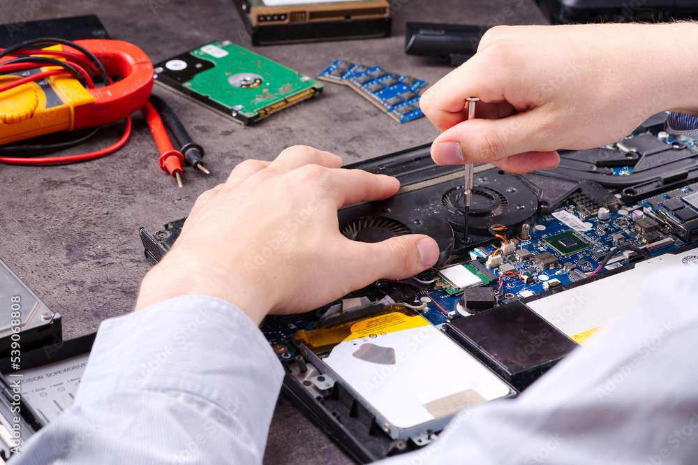 Poster hands fixing motherboard of pc or laptop notebook close up in service. laptop repair service. pc har