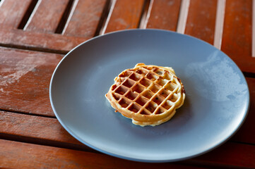 A type of Thai dessert made from flour, sugar and coconut milk. It's on a plate on the table.