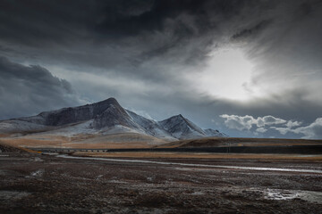 Fototapeta premium Snow mountain and river against cloudy weather