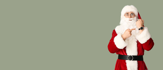 Surprised man in Santa costume and with watch on color background with space for text. Christmas countdown concept