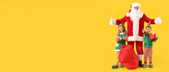Cute little elves with Santa Claus and Christmas gifts on yellow background with space for text