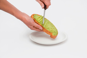 Bread with guacamole spread. On white background