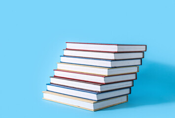 Ladder made of books on color background