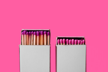 Boxes with new matches on pink background, closeup
