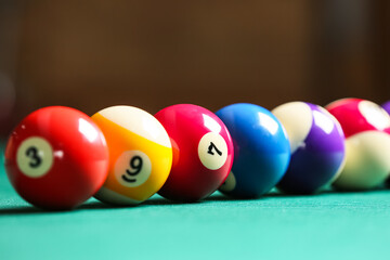 Colorful billiard balls on table, closeup