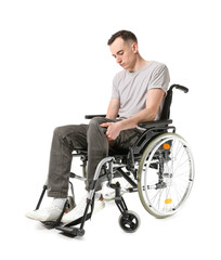 Obraz na płótnie Canvas Young man in wheelchair isolated on white