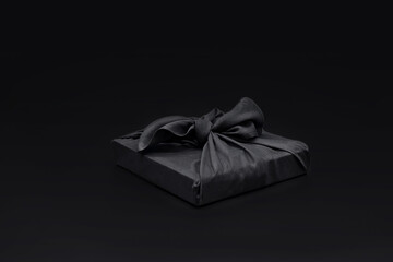 Black friday gift box wrapped in fabric with copy space. Traditi