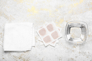 Mustard plasters with bowl of water and towel on grunge background