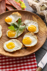 Plate with tasty fried quail eggs on table, closeup