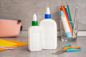 Bottle of glue on grunge background, closeup