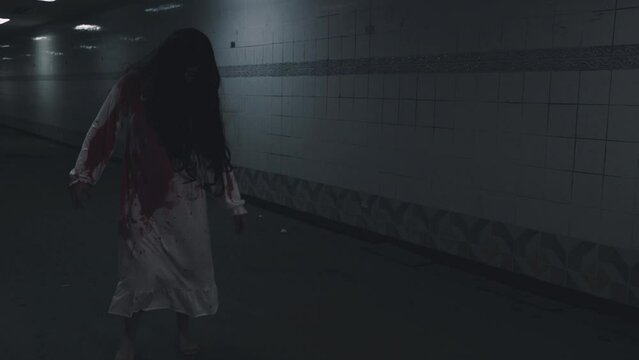 Scary zombies ghost walking. Asian woman ghost horror creepy scary have hair covering face with blood walk following camera at abandoned dark tone, female makeup zombie, Happy Halloween day