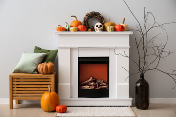 Interior of living room decorated for Halloween with fireplace and pumpkins