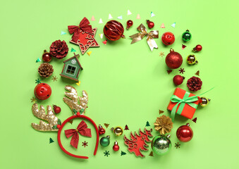 Frame made of different Christmas decor on green background