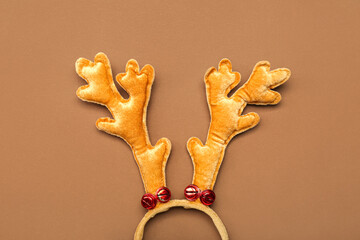 Funny Christmas reindeer horns on color background