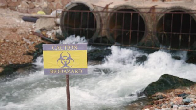 Close up of warning sign lable biohazard caution of collects sample of waste water from industrial, Conserve water and Environment Issue concept