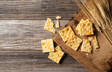 Cracker placed against old wooden background.