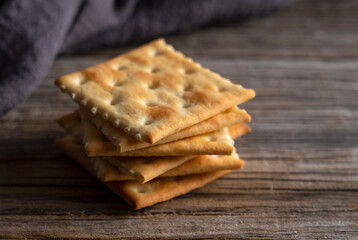 Cracker placed against old wooden background.