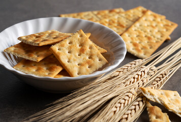 Cracker placed on dark stone background.