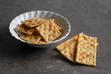 Cracker placed on dark stone background.