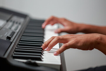 Fototapeta na wymiar Close-up of male hands playing keyboard