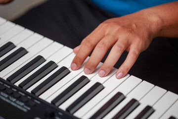 Close-up of male hands playing keyboard