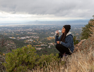 Woman drinking water on summit