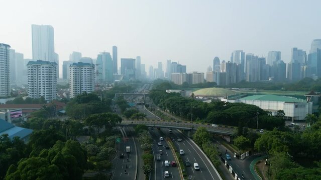 Traffic on the tollway with skyscraper at morning