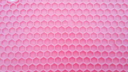 pink background with honeycomb motif
