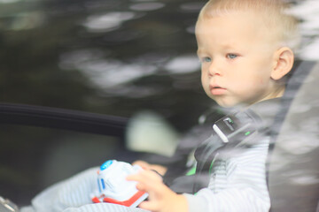 kid rides in a child seat in the car