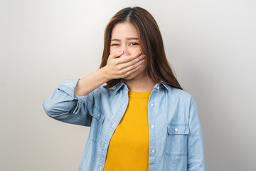 Portrait of pretty brunette hair, disgust smell bad breath strong asian young woman, girl covering,...