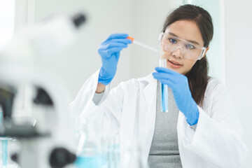 Medical development research laboratory, chemist or science woman scientist student in glass, glove looking pipette for test analysis liquid samples in clinic lab. Microbiology, analysing for medicine