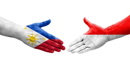Handshake between Indonesia and Philippines flags painted on hands, isolated transparent image.