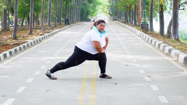 Fat woman stretching legs on the road