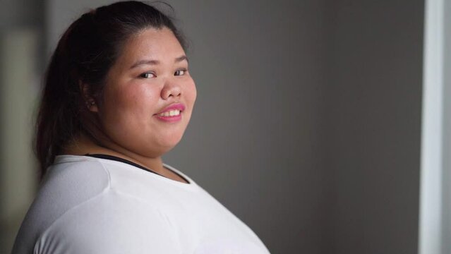 Side view of fat woman smiling at the camera