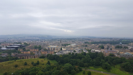A sprawling landscape view of Edinburgh city from popular Scottish walkway of Arthur's Seat in Scotland