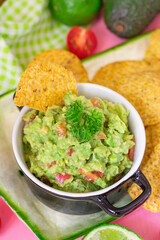 Traditional Mexican avocado dip Guacamole served with tortilla chips