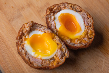 Homemade English Scotch Eggs Wrapped in Sausage close up 