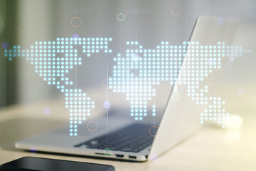 Multi exposure of abstract creative digital world map on laptop background, research and analytics concept